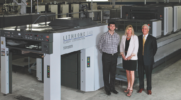 L to R Brett, Karen and John Hueston beside a Komori installed at Barney Printing