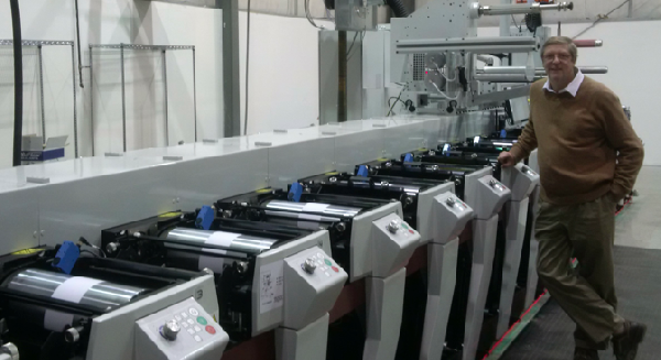 John Stubbs CEO/General Manager beside new 10 colour Mark Andy