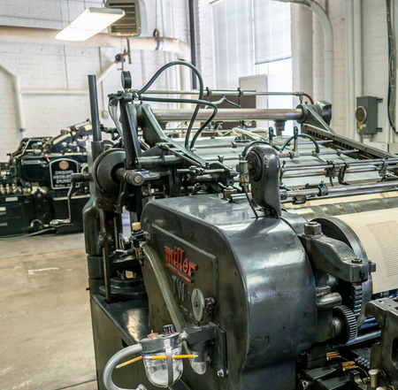 Pressroom full of letterpresses using metal type 