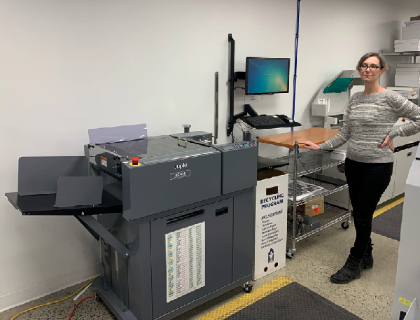 Kasey Baillie, Production Supervisor with the Duplo DC-618 Slitter Cutter Creaser