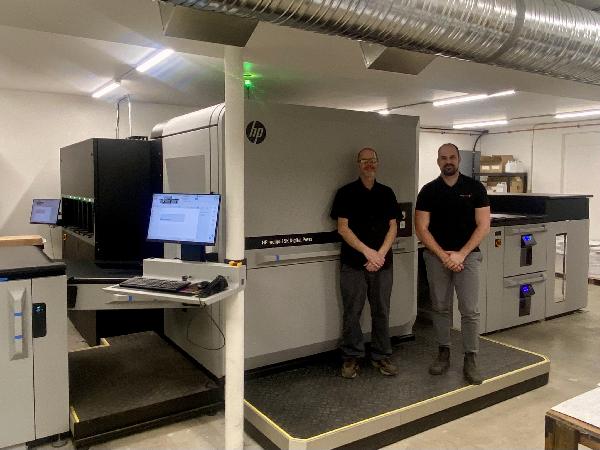 L to R Jason Baccaert, operator, Nick Giesbrecht, owner in front of a new HP Indigo 15K Digital Press.