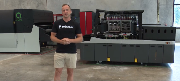 Printeez Vice President Alex Sckoropad with the equipment at new American plant. 
